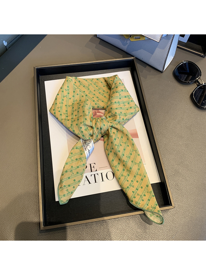 Yellow Green bow-and-flower square scarf tied in a loose knot