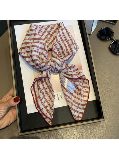 Close view of the Red White scarf's striped bow pattern and finished edge