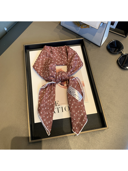 Red bow-and-flower square scarf tied in a loose knot