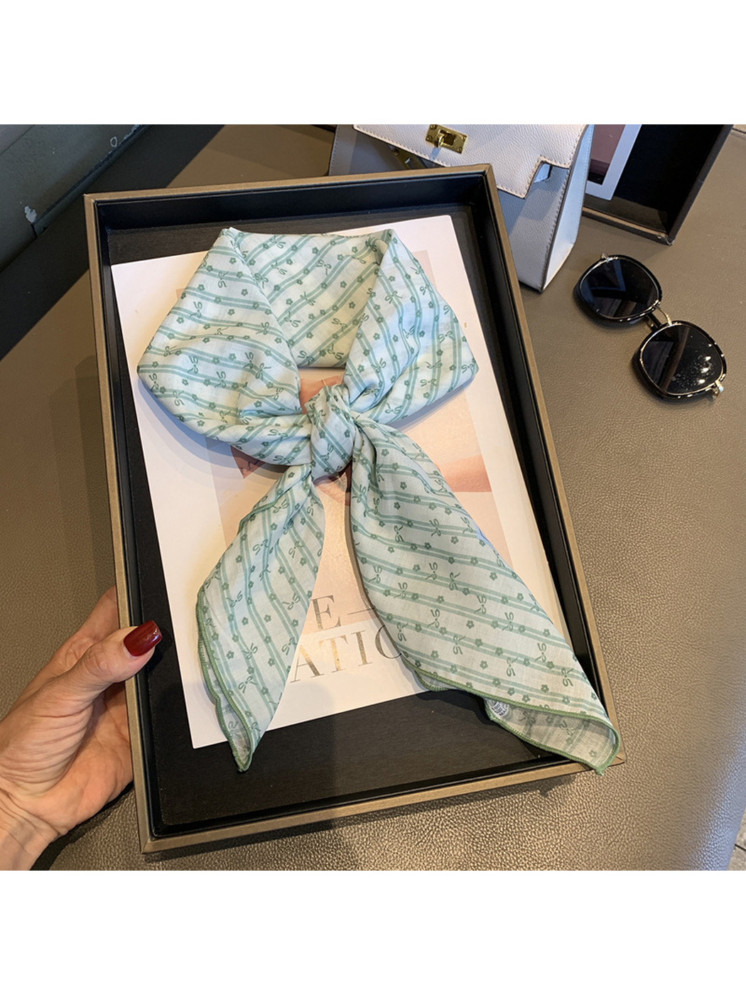 Beige Green bow-and-flower square scarf tied in a loose knot