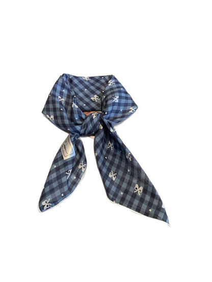 Navy gingham scarf with bow motifs, tied view
