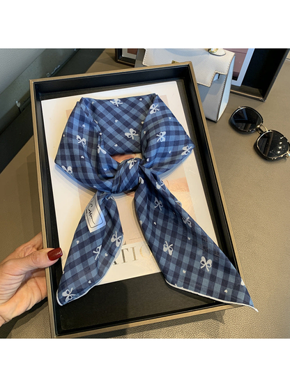 Navy gingham bow-print scarf tied and displayed in a tray