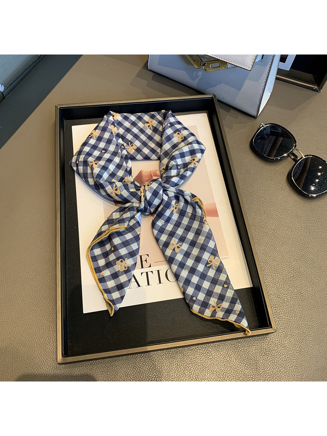 Navy Orange gingham scarf with bow motifs, tied view