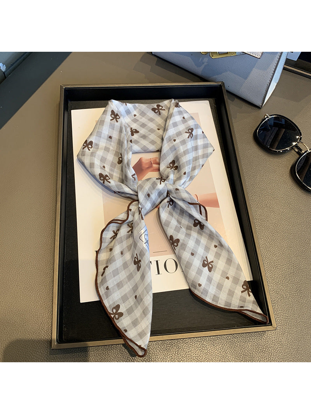 Beige gingham scarf with bow motifs, tied view