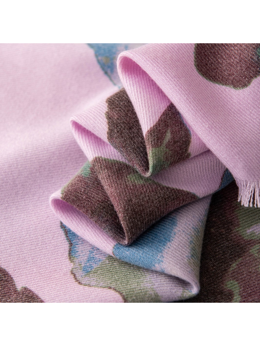 Close-up of the purple floral scarf's woven-look texture and short fringe