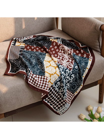 Patchwork square scarf draped across an upholstered chair
