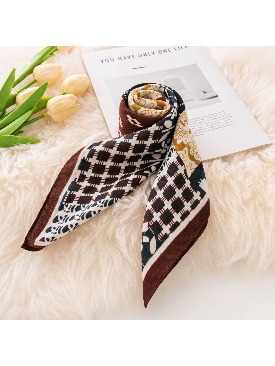 Patchwork square scarf rolled with two pointed ends extended