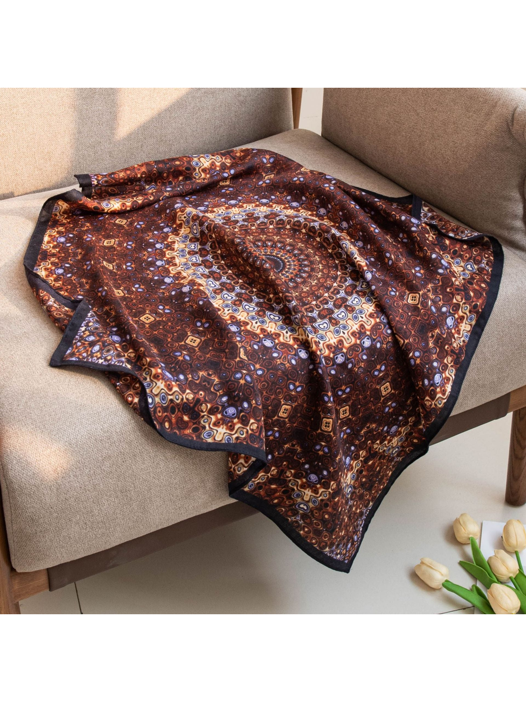 Brown geometric square scarf draped across a chair