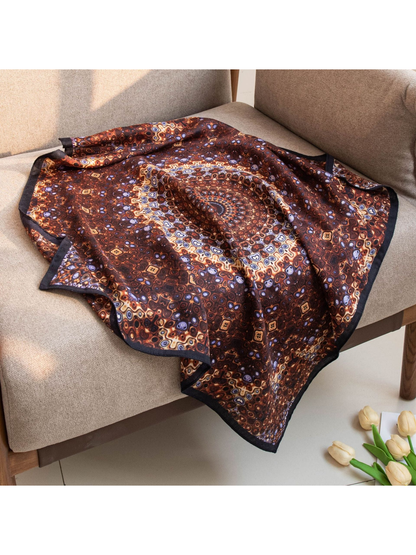 Brown geometric square scarf draped across a chair