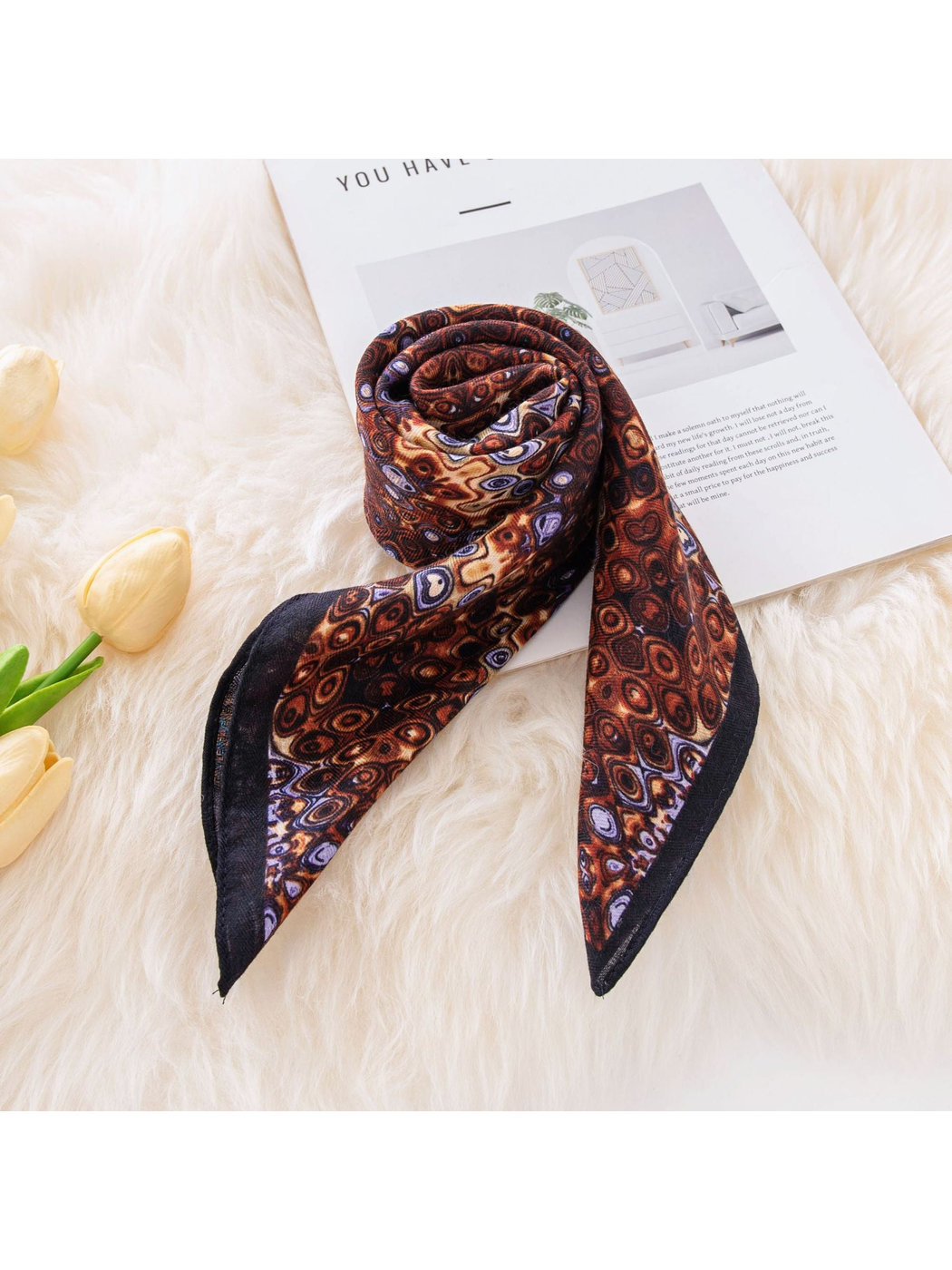 Brown geometric square scarf loosely rolled with pointed ends visible