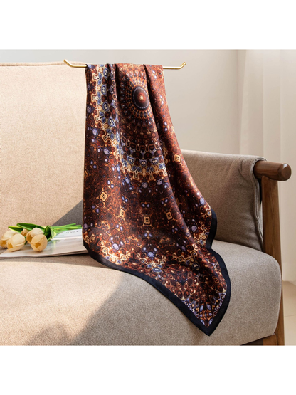 Brown medallion-print square scarf hanging over a chair