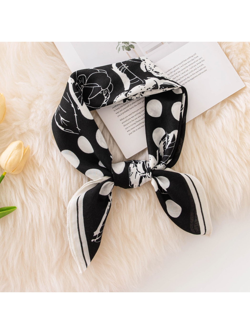 Black polka dot and floral square scarf styled in a bow