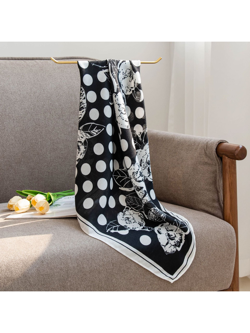 Black floral and polka dot square scarf hanging over an armchair