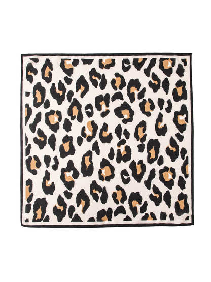 Black, tan and ivory cow print square scarf laid flat with black border