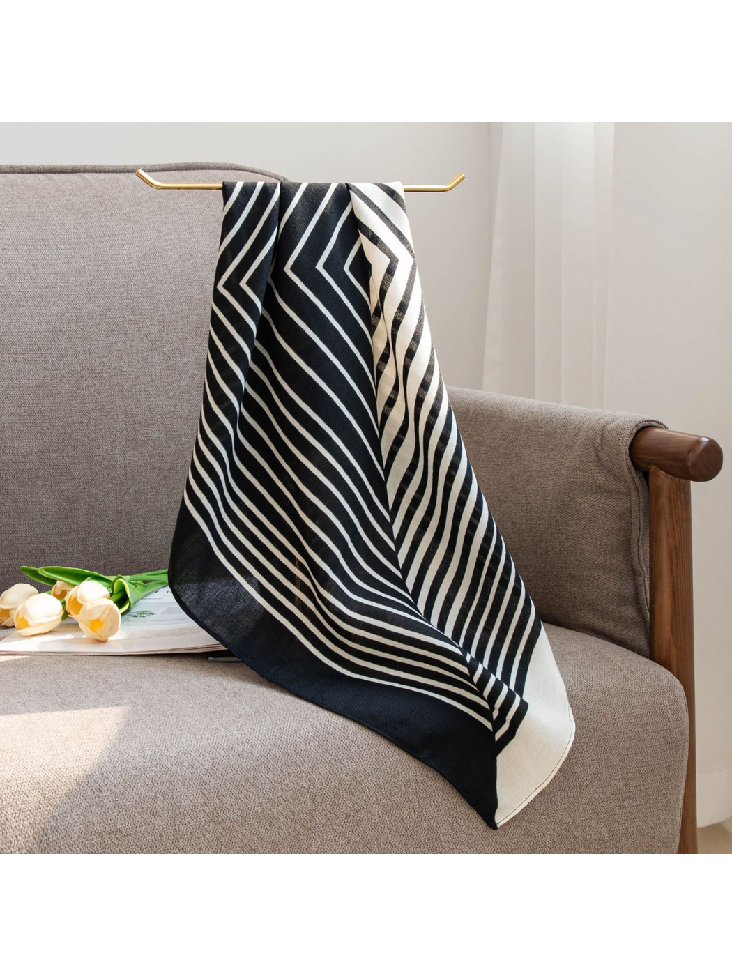 Black and ivory striped square scarf draped over a chair