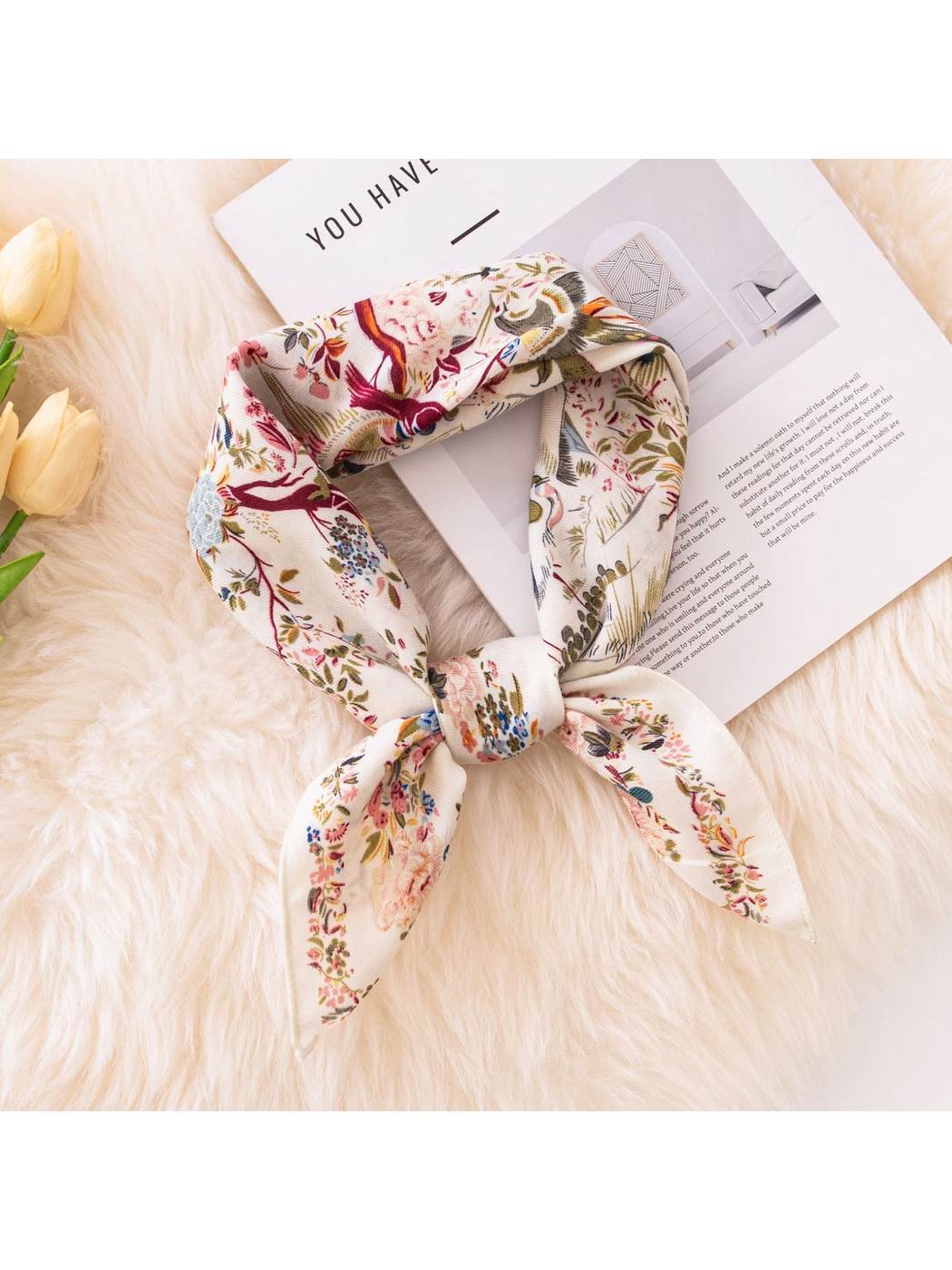 Ivory bird-and-floral square scarf tied in a neckerchief-style knot