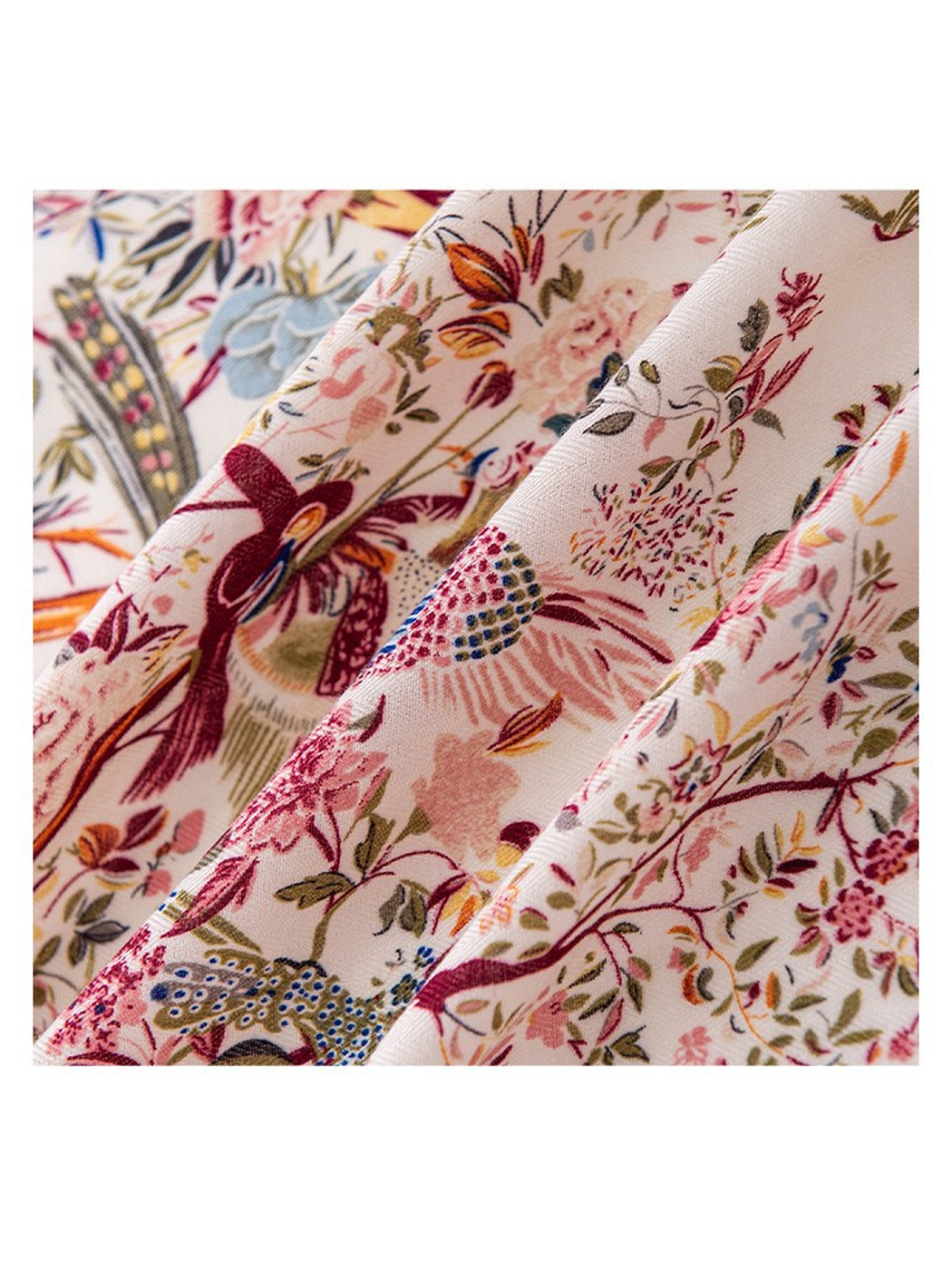 Close-up of the colorful bird-and-floral print and fine diagonal woven-look texture