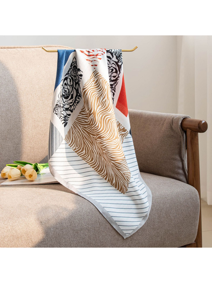 Multicolor square scarf hanging over a neutral armchair