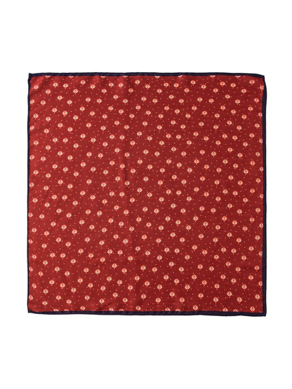 Red square scarf with cream leaf motifs and navy border, flat view