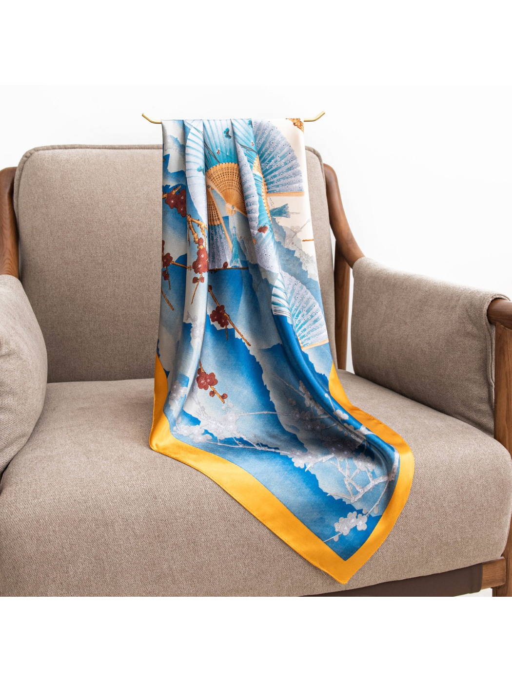 Blue and ivory square scarf with folding fans and gold-tone border, draped view