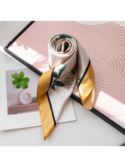 Rolled floral scarf showing the gold border and smooth patterned surface