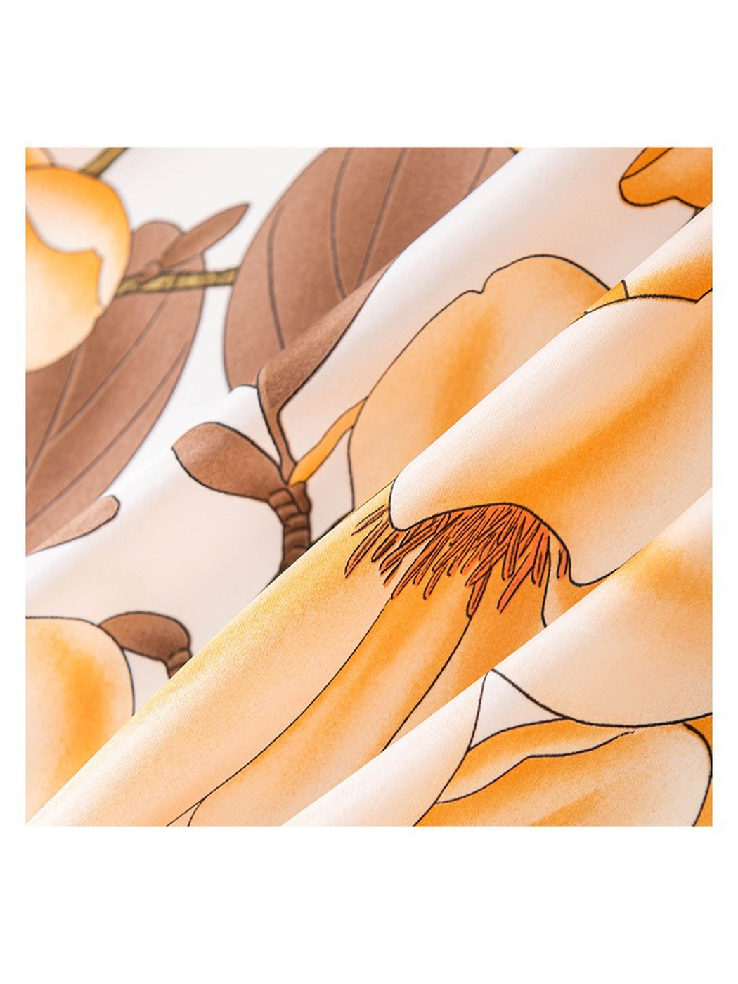 Close-up of orange-toned blossoms and brown leaves on the scarf