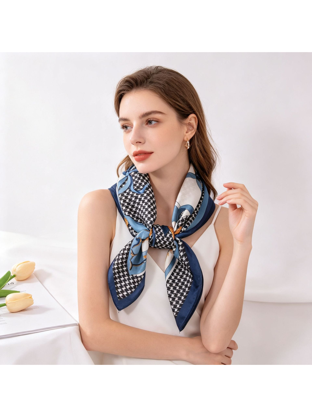 Blue, navy and black patterned square scarf tied around the neck