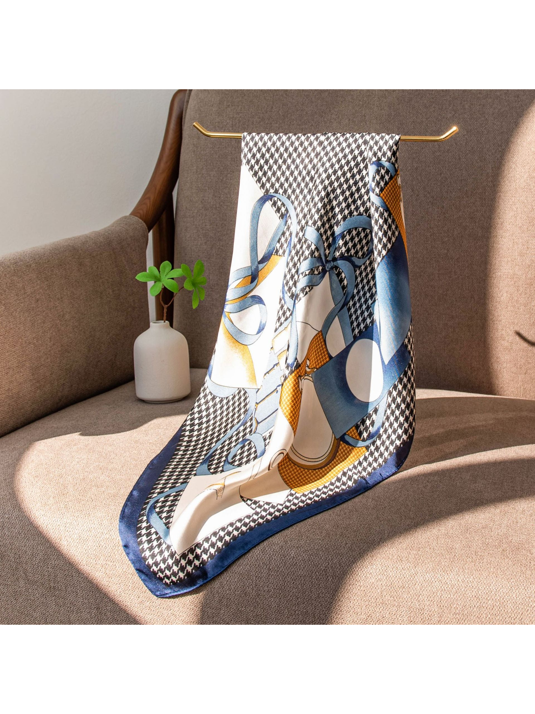 Square scarf displayed open over a neutral upholstered chair