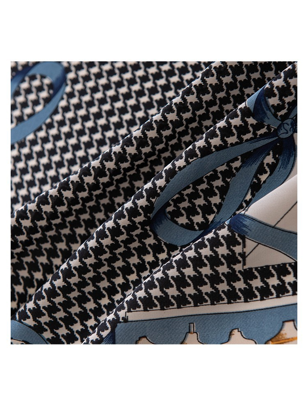 Close-up of the black houndstooth pattern and blue ribbon print