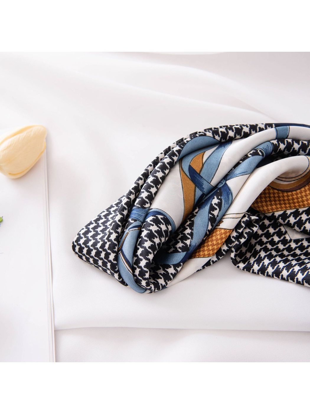 Close-up of the scarf's smooth folds and houndstooth print
