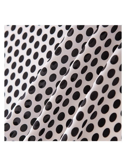 Close-up of the black polka-dot pattern and smooth scarf surface
