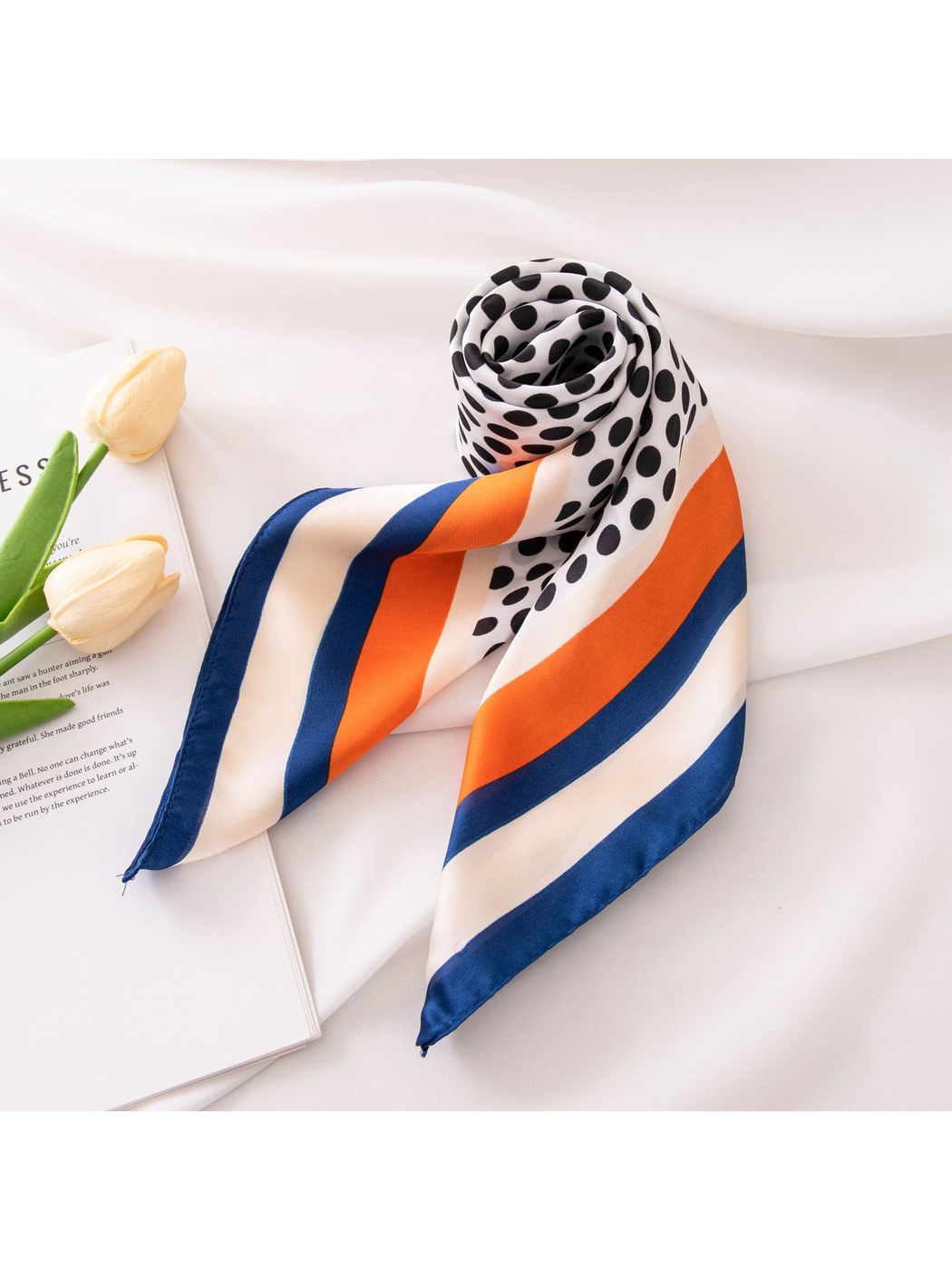 Polka-dot square scarf rolled with orange, ivory, and navy striped ends