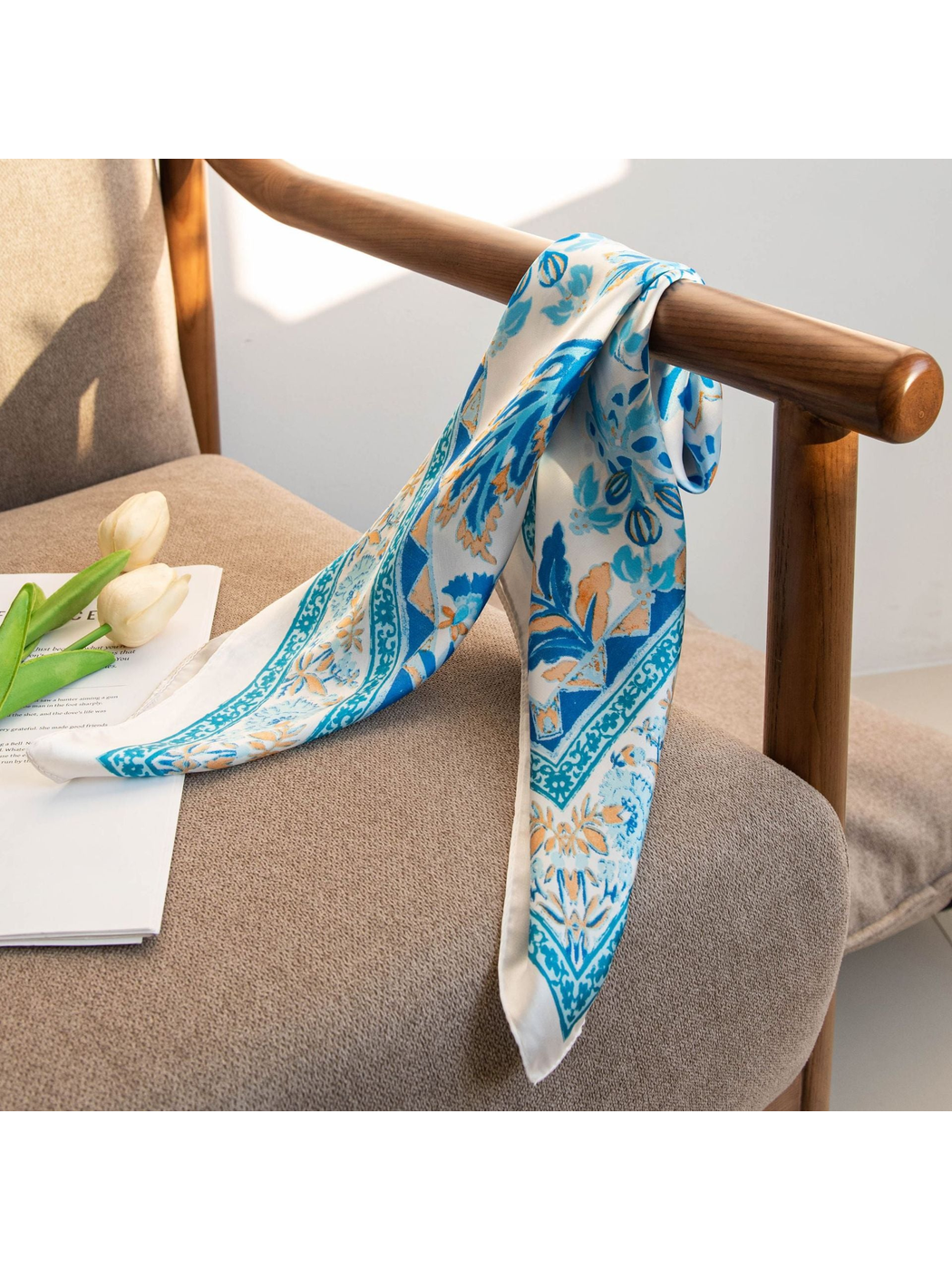 Blue floral scarf draped over a wooden chair arm with pointed ends
