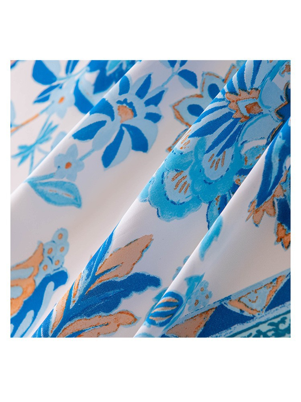Close-up of the blue floral print and smooth scarf surface