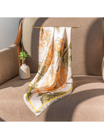 Peach rose and olive leaf scarf draped over a chair