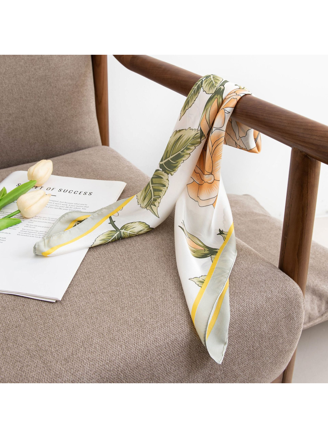 Floral square scarf draped over a wooden chair arm