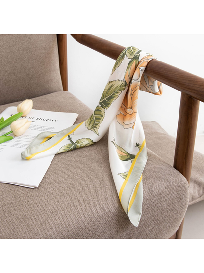 Floral square scarf draped over a wooden chair arm