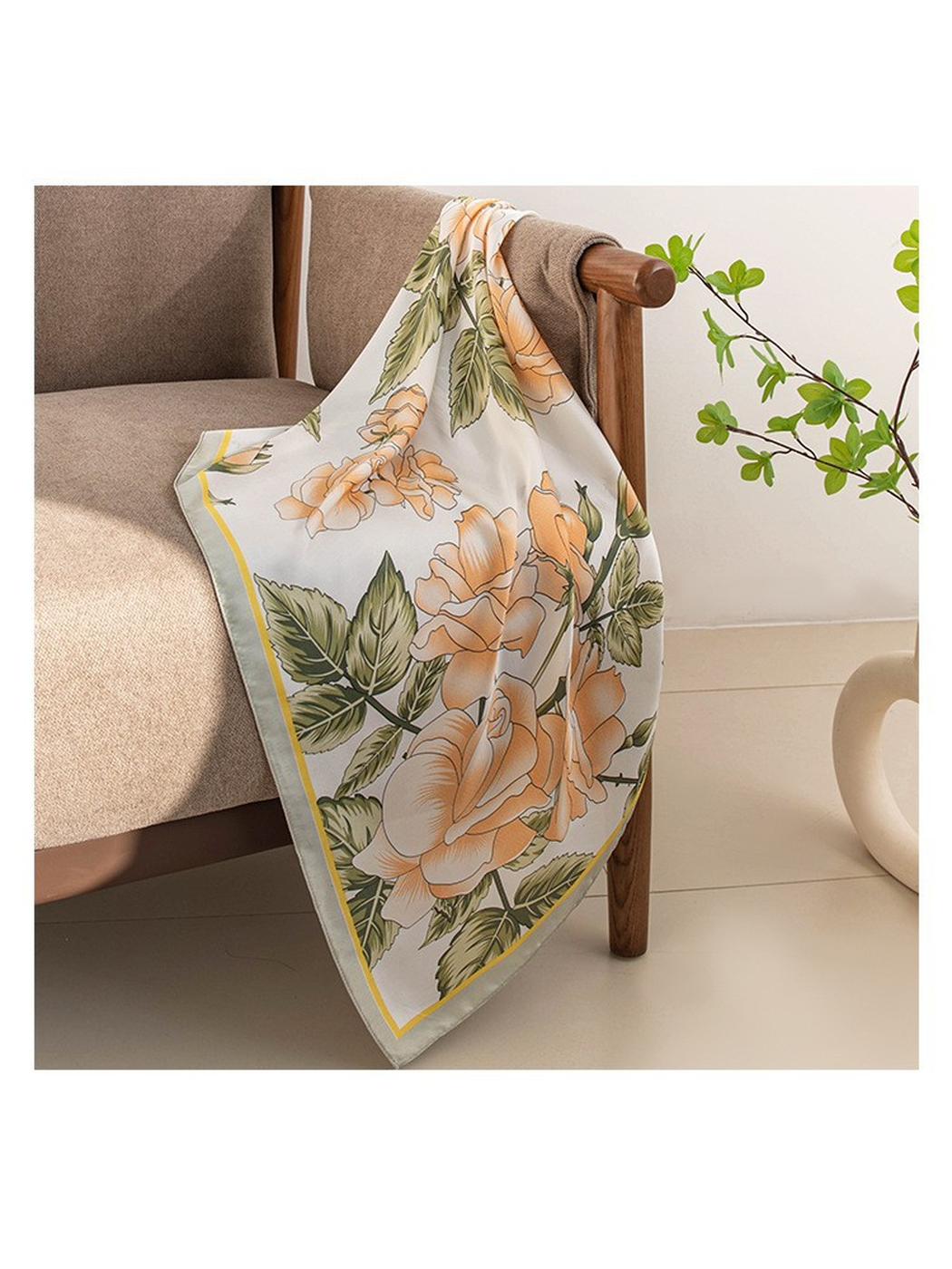 Floral square scarf opened and draped over a chair arm