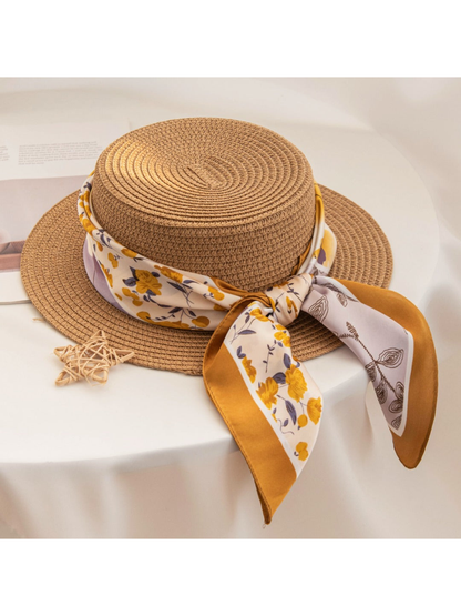 Floral square scarf tied around a woven-look hat