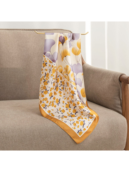 Ochre and lavender floral square scarf draped over an armchair