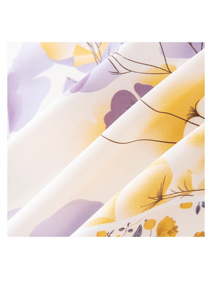 Close-up of the scarf's smooth satin-look surface and botanical print