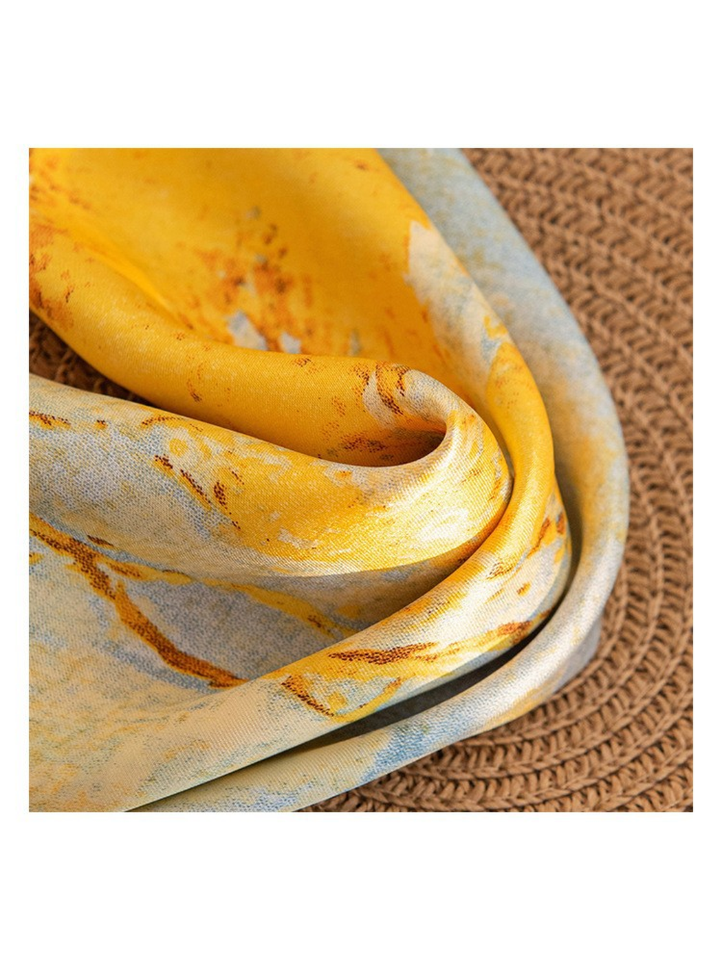 Close-up of the scarf drape with a fine visible weave and smooth sheen