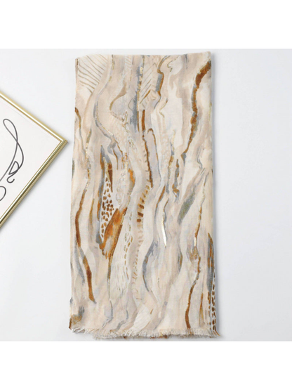 Neutral-toned abstract print scarf folded to show the pattern and fringed edge