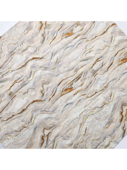 Expanded view of the neutral abstract wavy pattern and scattered gold-tone accents