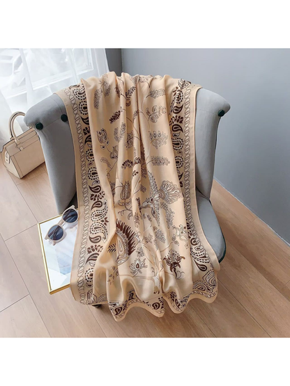 Beige paisley scarf with bird and botanical motifs, full-length draped view