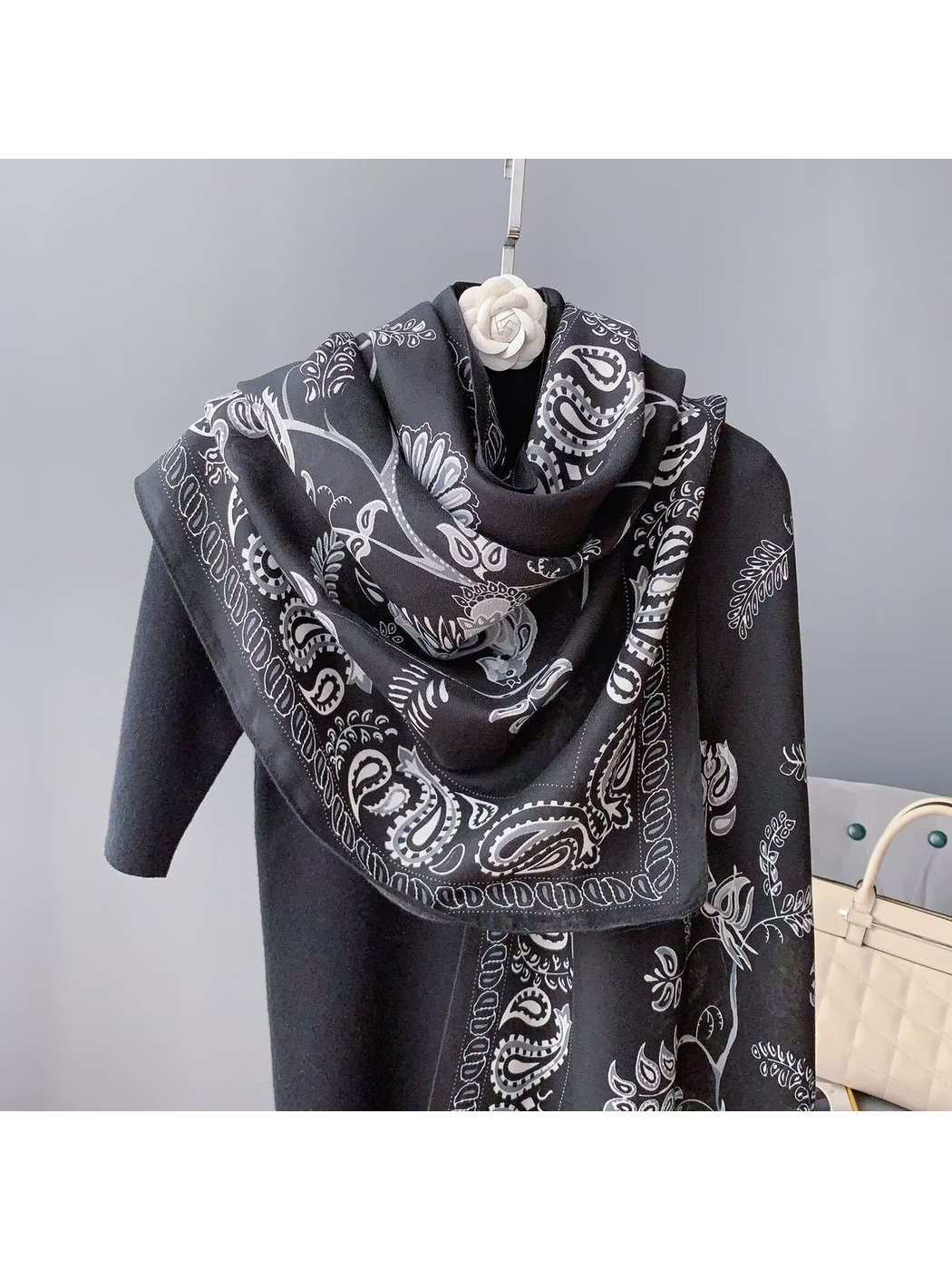 Black paisley scarf with bird and botanical motifs, draped front view
