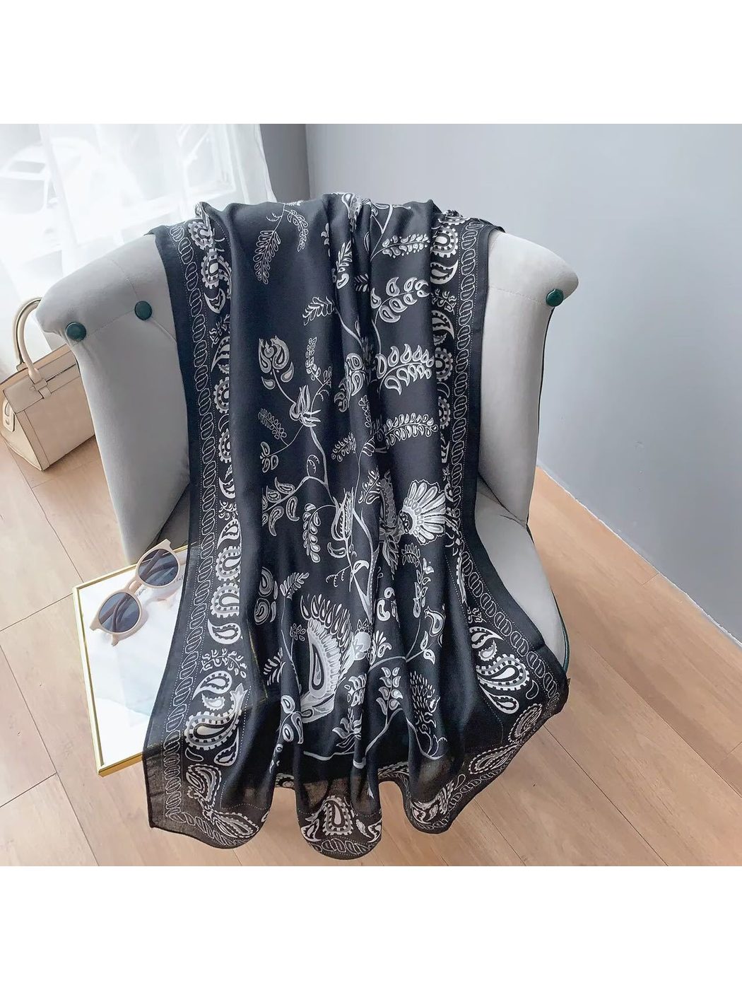 Black paisley scarf displayed full length over a chair