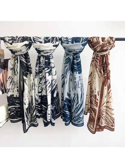 Brown, Blue, Black and Navy abstract-pattern scarves displayed together