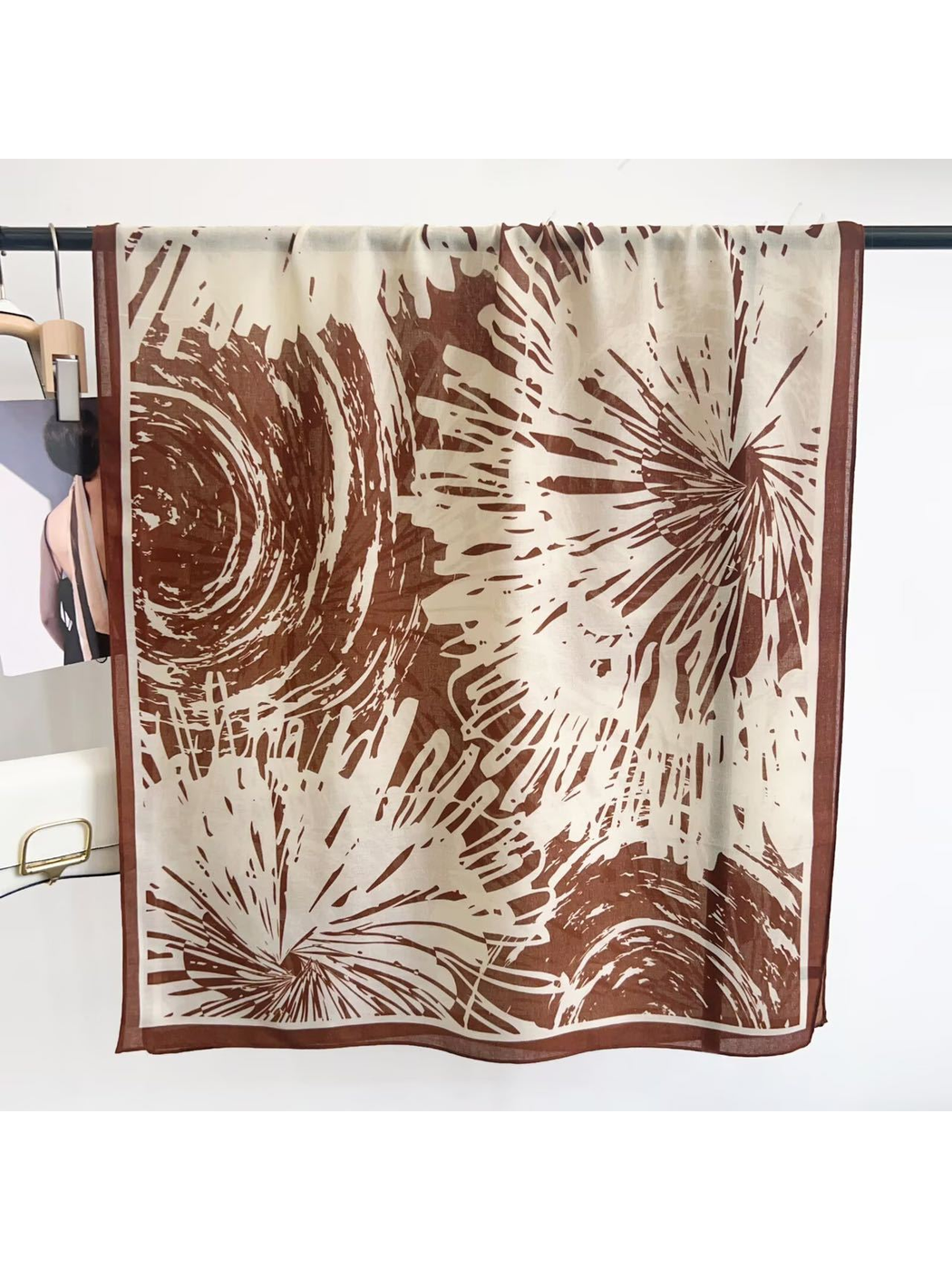 Brown abstract-pattern scarf displayed open with contrasting border