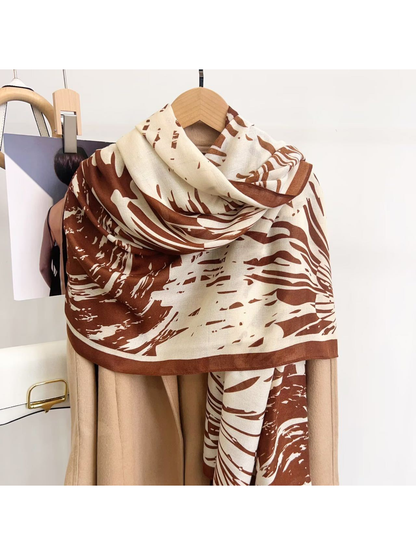 Brown abstract-pattern scarf draped over a coat